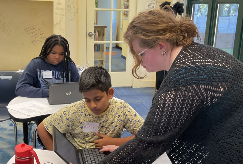 Lead Instructor Carleysue Mayes helping a beginner student build thier website